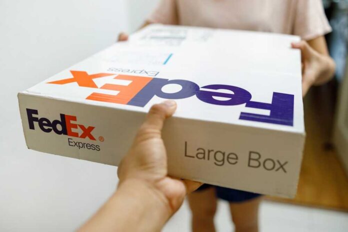 Person handing over a FedEx package to another individual
