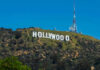 Hollywood sign on a green mountain hillside.