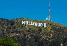 Hollywood sign on a green mountain hillside.