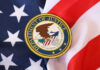 DOJ Caught in Illegal Move Department of Justice seal on American flag.