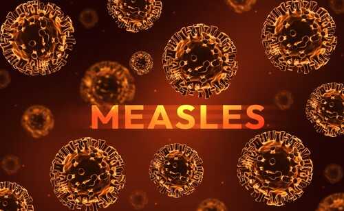 Illustration of measles virus particles with the word 'MEASLES' in bold