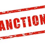 Red stamp with the word 'SANCTIONS' in bold letters
