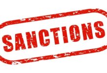 Red stamp with the word 'SANCTIONS' in bold letters