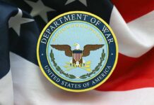 Pentagon Livestream Doubts Explode Emblem of the Department of War on a background of the American flag