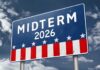 Election sign reading Midterm 2026 against a cloudy sky