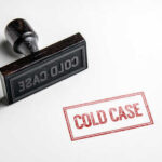 Rubber stamp with the words COLD CASE next to a stamped impression